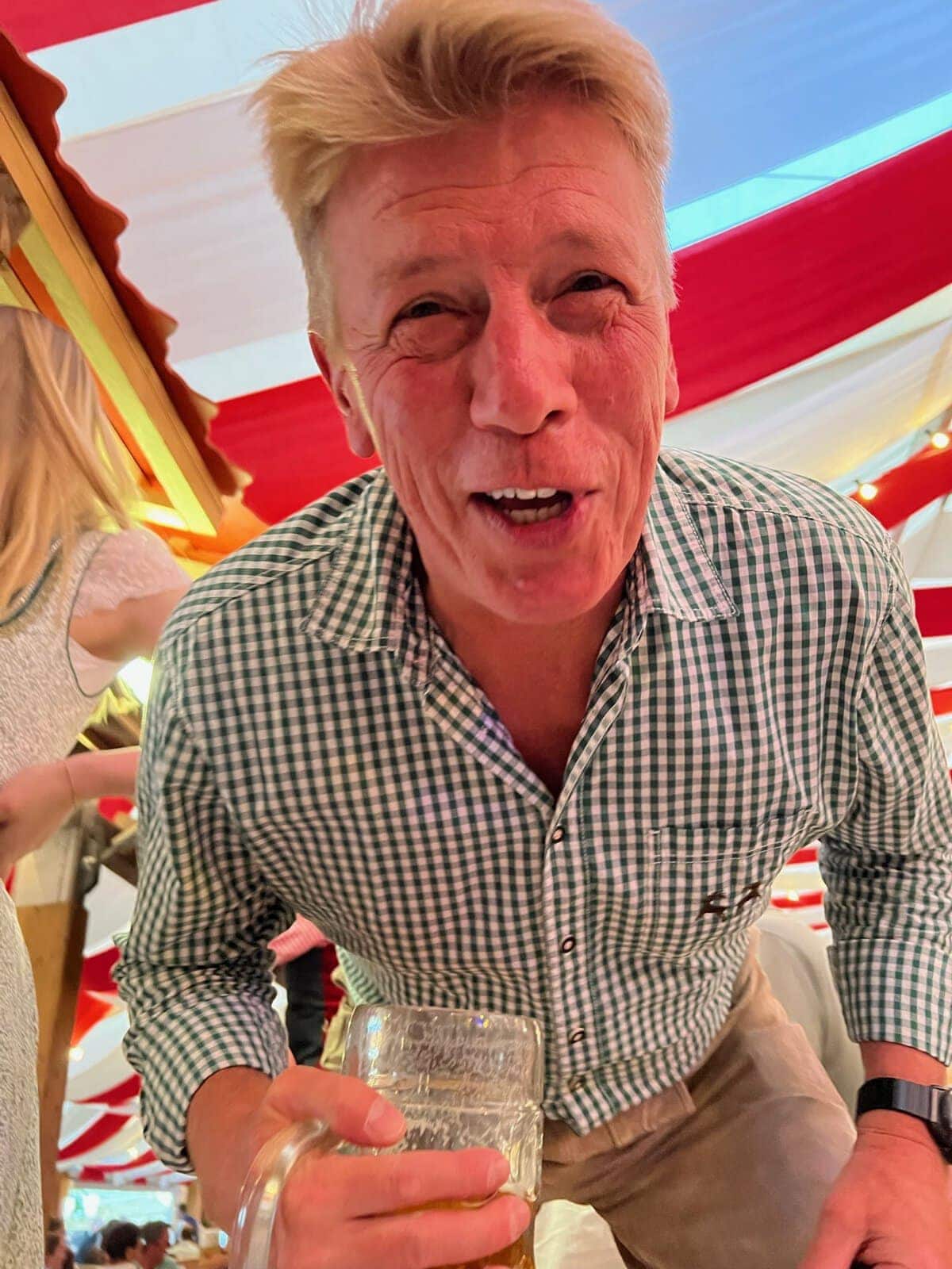 Vibrant man enjoying beer at a European beer festival, celebrating craft brews and beer tours in Europe.